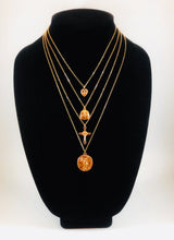 Load image into Gallery viewer, Set of four gold necklaces that can be layered or worn separately. Set includes Heart Charm with Rhinestone North Star Necklace, Compass Charm Necklace, Cross Charm Necklace, and Coin Charm Necklace.  Approximately 16-18-20-22&quot; Length, with Clasp Closure with 3&quot; Ball Extension.