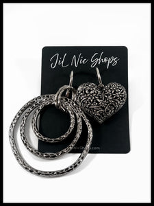 Mismatched Oversized Hammered Open Circle and Heart Drop Earrings Color: Oxidized Silver Approx. Cirlce 4.0" Length x 2.75" Width & Heart 2.5" Length x 2.0" Width Click Back